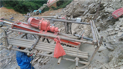 borehole drilling machine for drill holes in rock
